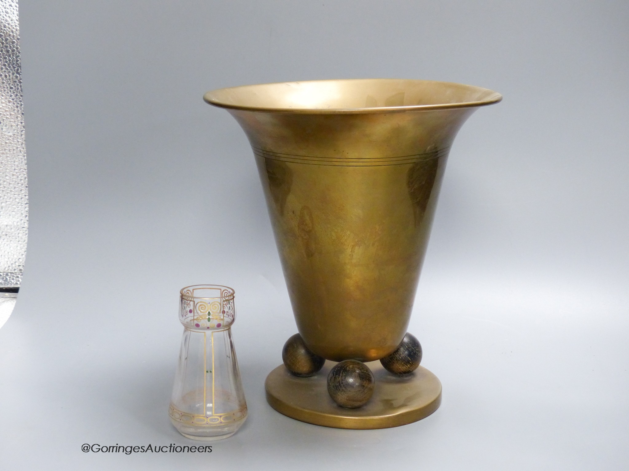 A Hoffman style brass vase and a small secessionist style glass vase, 24cm tall